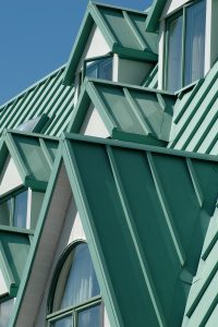 dormer windows in a green metal standing seam roof