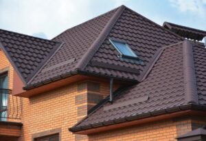 A brown tile-style metal roofing system on a residential house